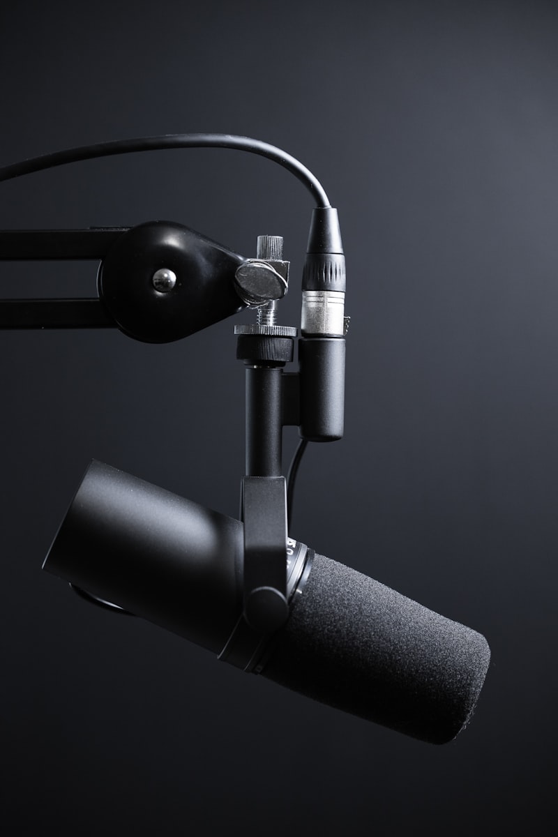 alt: A person wearing headphones smiles while reviewing podcast analytics on a tablet