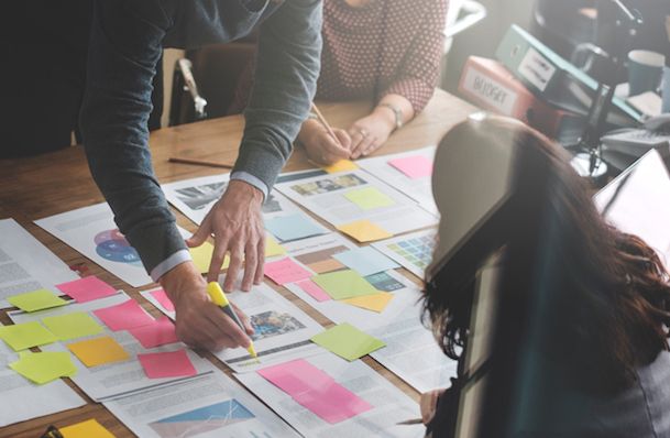 A content team collaborating on the design and layout of a professional white paper