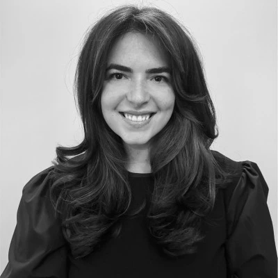 A woman smiling at camera to represent human expertise in the AI era