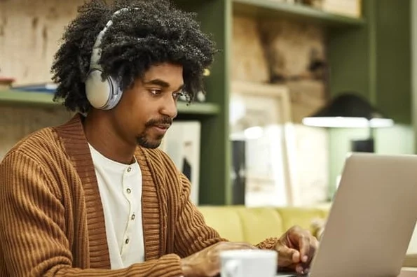 A professional working at a laptop to refine content strategy