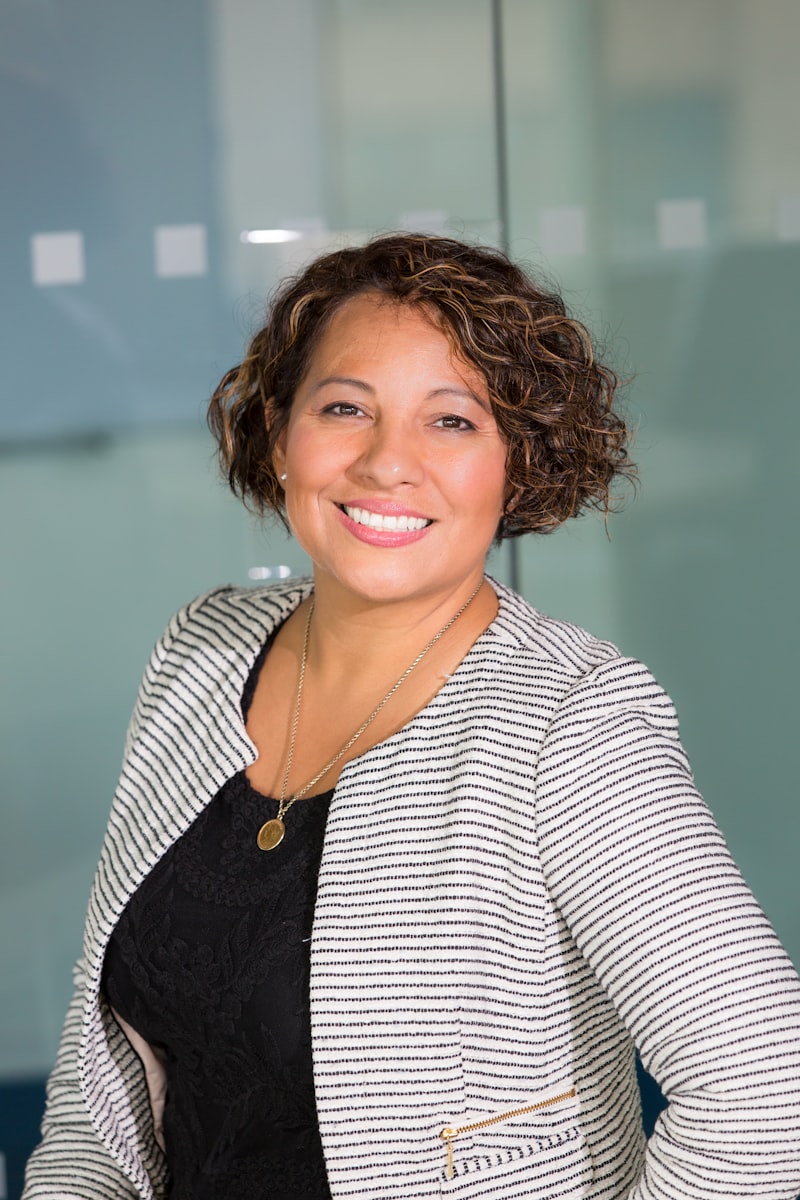 alt: A customer service representative smiling while typing on a computer