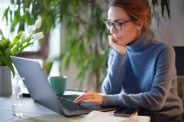 Woman submitting a Google disavow file to protect her website's ranking.