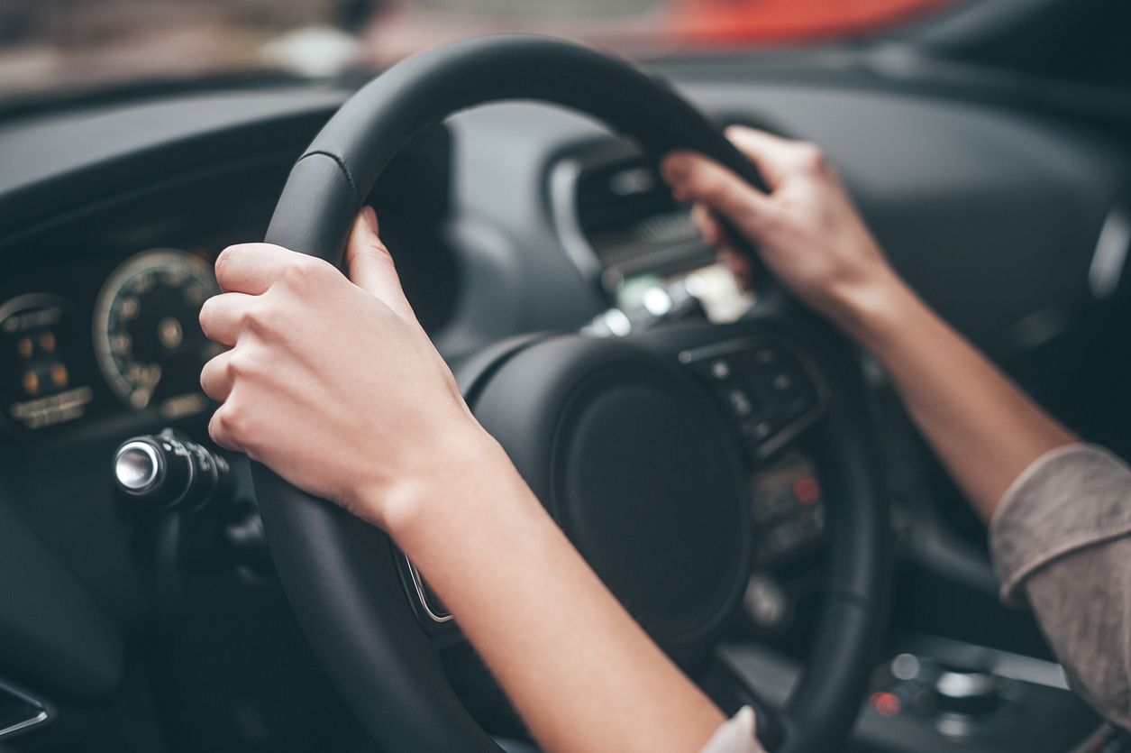 Người lái giữ vô lăng, thể hiện dấu hiệu thước lái lệch, cần kiểm tra định kỳ.
