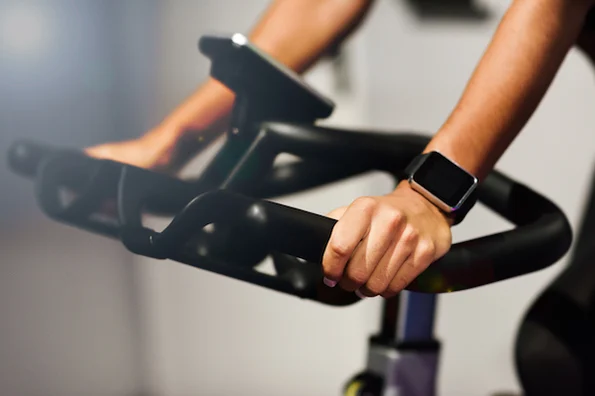 A person using a stationary bike for a home workout