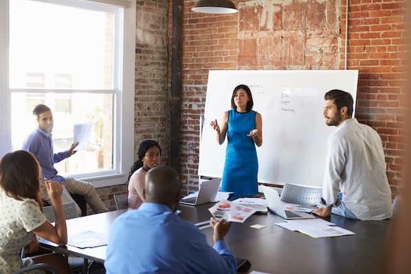 Team collaborating in a meeting using productive marketing meetings strategies