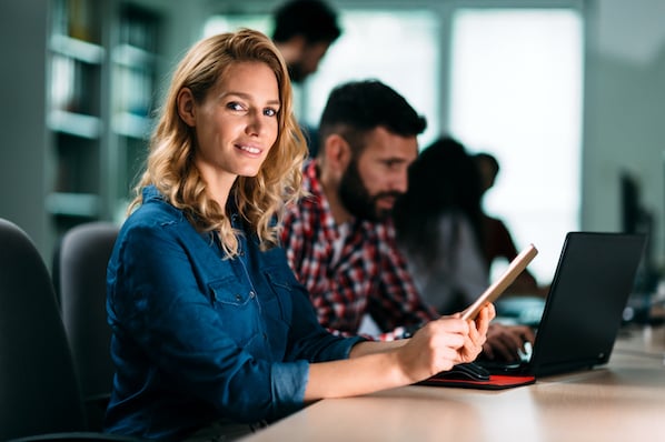 A marketer analyzing data charts on a laptop to plan a product launch strategy