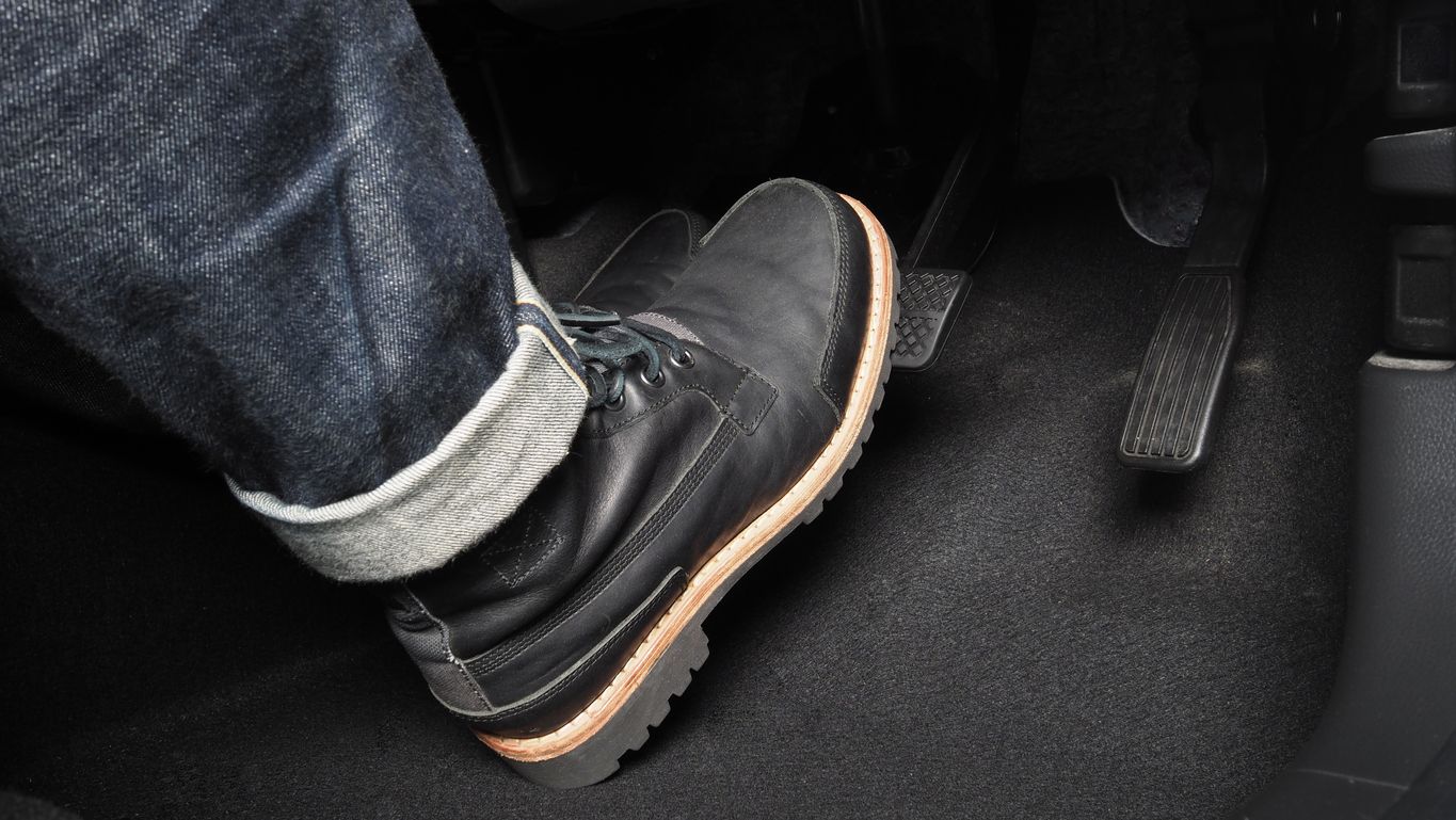 image of a boot pressing on a brake pedal