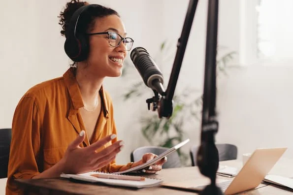 Podcaster recording a new episode in a home studio