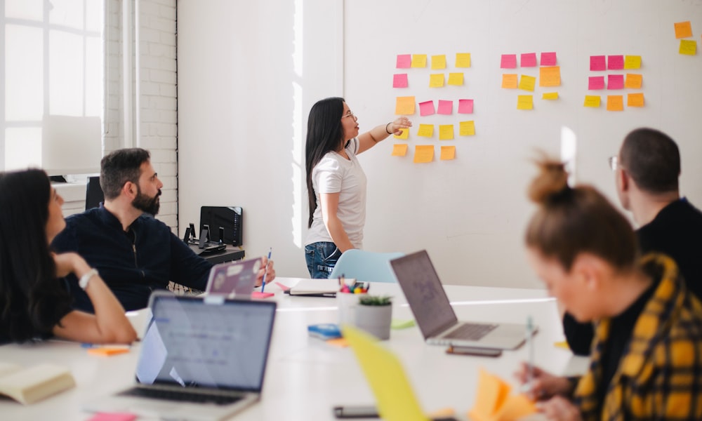 alt: A professional marketing team collaborating around a table with digital tablets and strategy documents