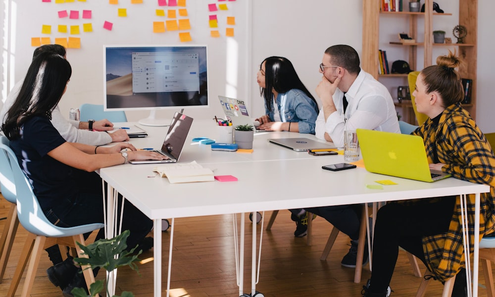 alt: A team brainstorming session with sticky notes and whiteboards illustrating a pilot program