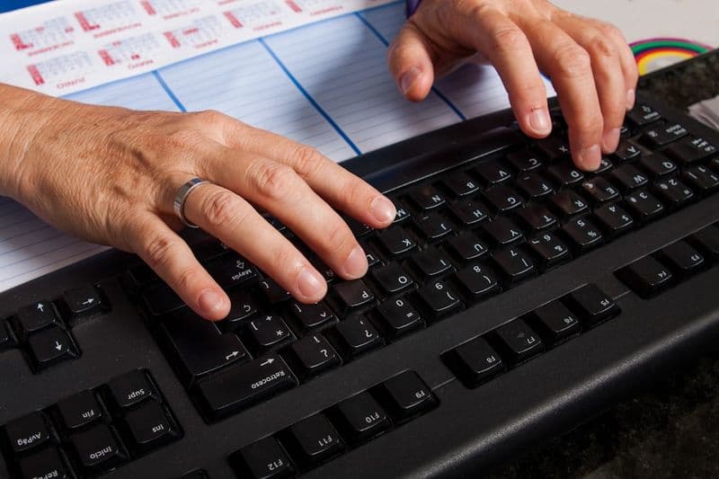 A person typing prompts into an AI chat interface