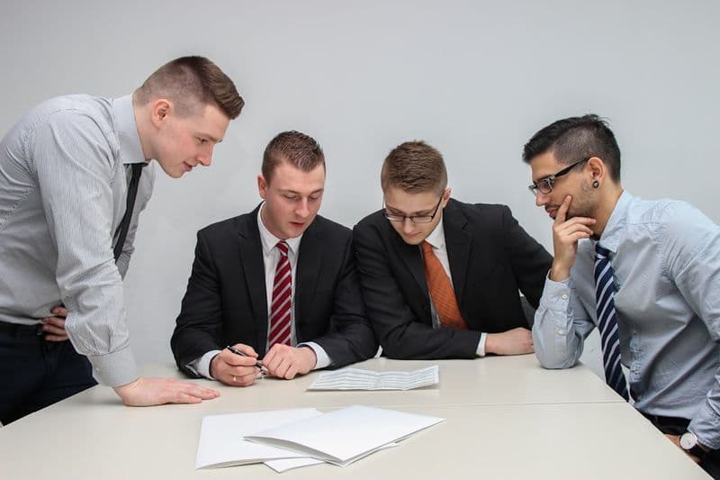A team reviewing a spreadsheet and testing plan